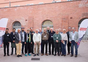  Panelists, organizers, and some participants of the 2023 symposium in Vienna, Austria. 