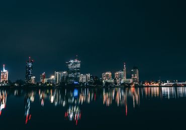 High-rise buildings lighten up the banks of the Danube.