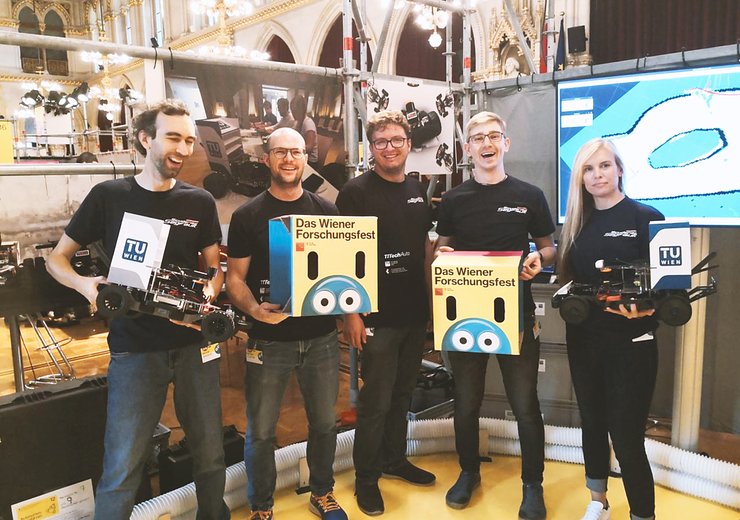 Andreas Brandstätter (l) and the autonomous race cars team were excited to meet visitors young and old. — Picture: Andreas Brandstätter / TU Wien Informatics
